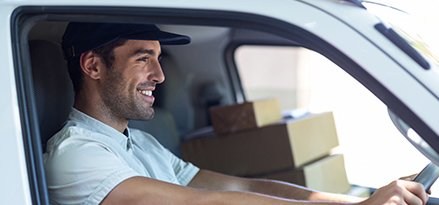 happy man in van with boxes